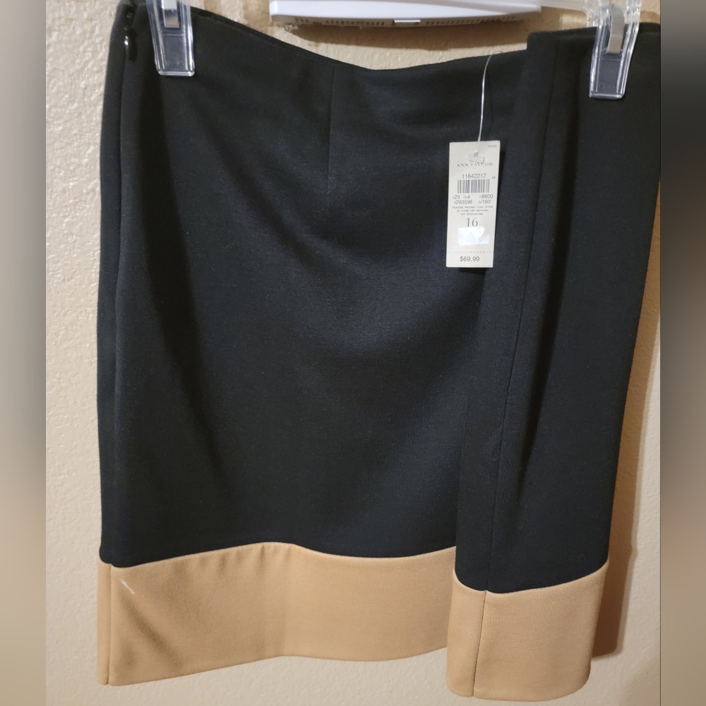 Black skirt with tan lower band.